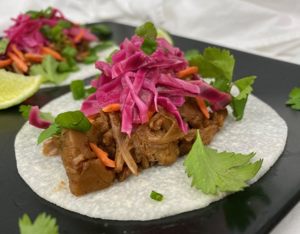 Plate of CHAR SIU JACKFRUIT garnished with pickled cabbage