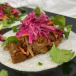 Plate of CHAR SIU JACKFRUIT garnished with pickled cabbage