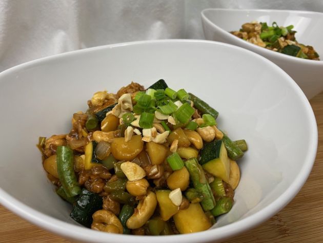 Asian inspired vegan meal in bowl with cashews vegetables and soy pieces