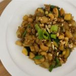 Vegan Asian inspired meal in bowl with cashews vegetables and soy pieces