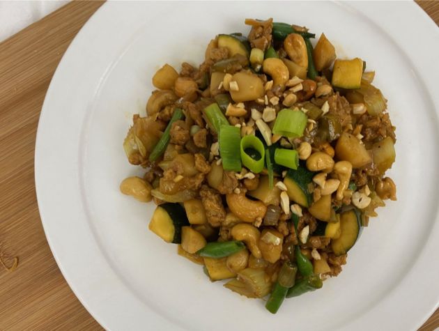 Vegan Asian inspired meal in bowl with cashews vegetables and soy pieces